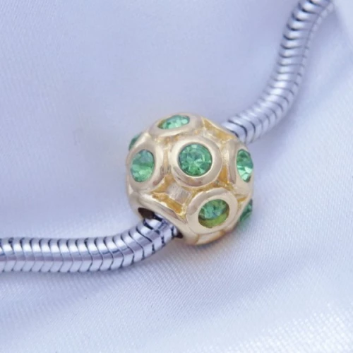 Korálek z chirurgické oceli zlacený se zirkony zelená